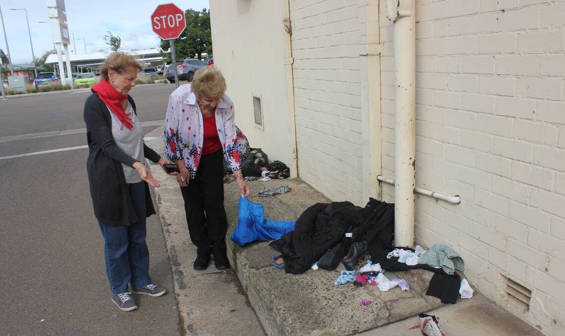 RUBBISH: St Vincent de Paul Goulburn assistant secretary Ruth Vial and president Wendy Wise inspecting some of the rubbish left in the lane way at the back of their Verner Street premises on Monday. Photo David Cole.