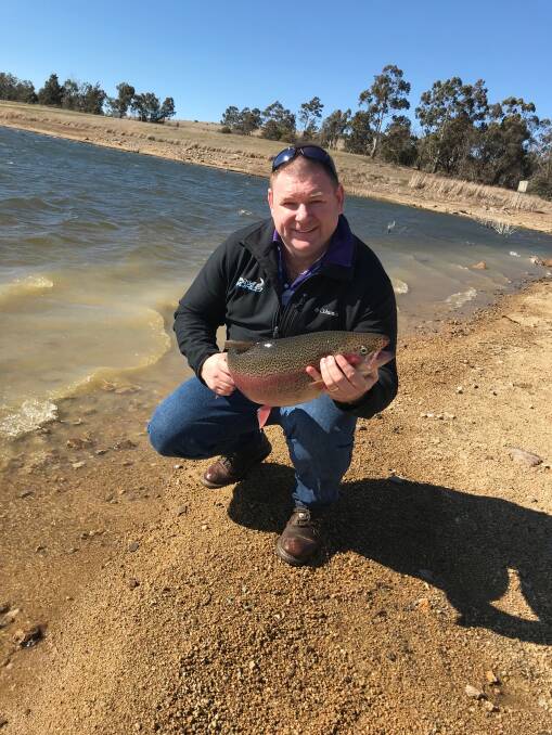 BIG FISH: Josh Lambert with one of the 100 breeder stock Rainbow Trout that were released into Pejar Dam recently. Photo supplied. 