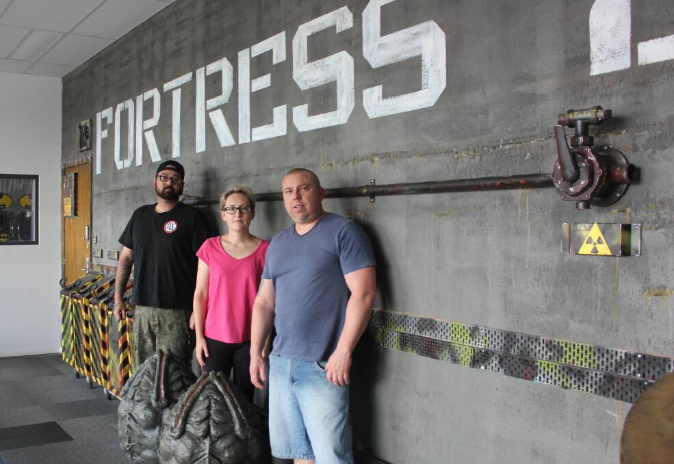 Family business: Back to the Arcade owner-operators Greg Appleton and wife Miranda Heath with staff member Callum Watt out the front of their laser tag facility that is presently being built. Photo: David Cole