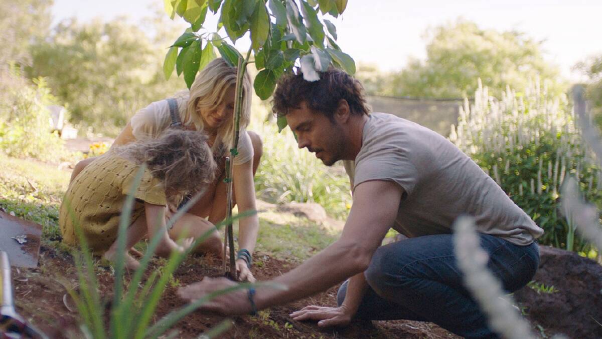 LEGACY: Damon Gameau planting a tree with his wife and child. Photo Fairfax Digital Collection. 