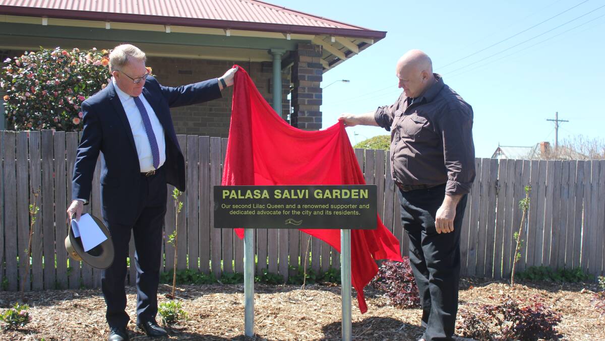 OPENING: Goulburn Mulwaree Mayor Bob Kirk and Bepi Salvi unveil the sign for the Palasa Salvi Garden on Tuesday in Howard Park. Photo: David Cole 