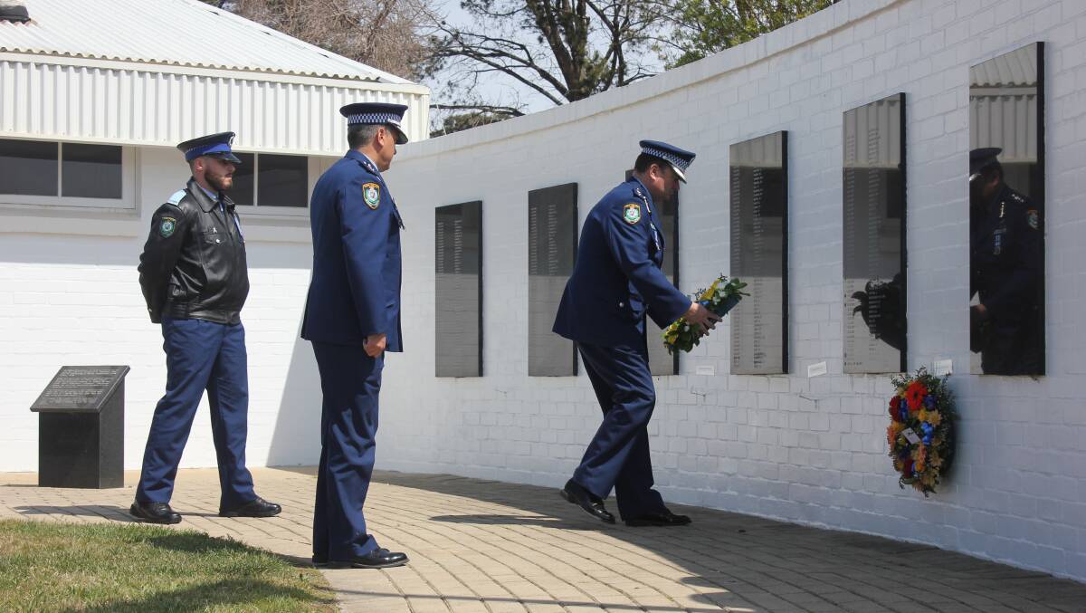 WREATH LAYING: Former Hume Superintendant Andrew Koutsoufis, Police Academy principal Evan Quarmby and student Joshua Hart laying a wreath on Friday. 
