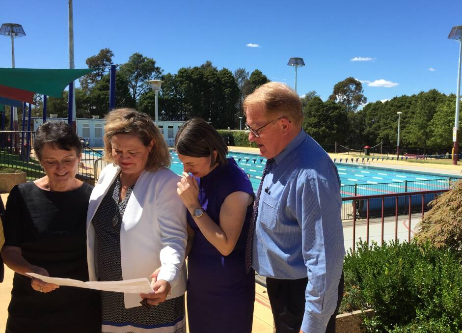 PLANS: Member for Goulburn Pru Goward, Liberal candidate for Goulburn Wendy Tuckerman, NSW Premier Gladys Berejiklian and Goulburn Mulwaree Mayor looking at plans for Stage One of the Aquatic Centre redevelopment. 