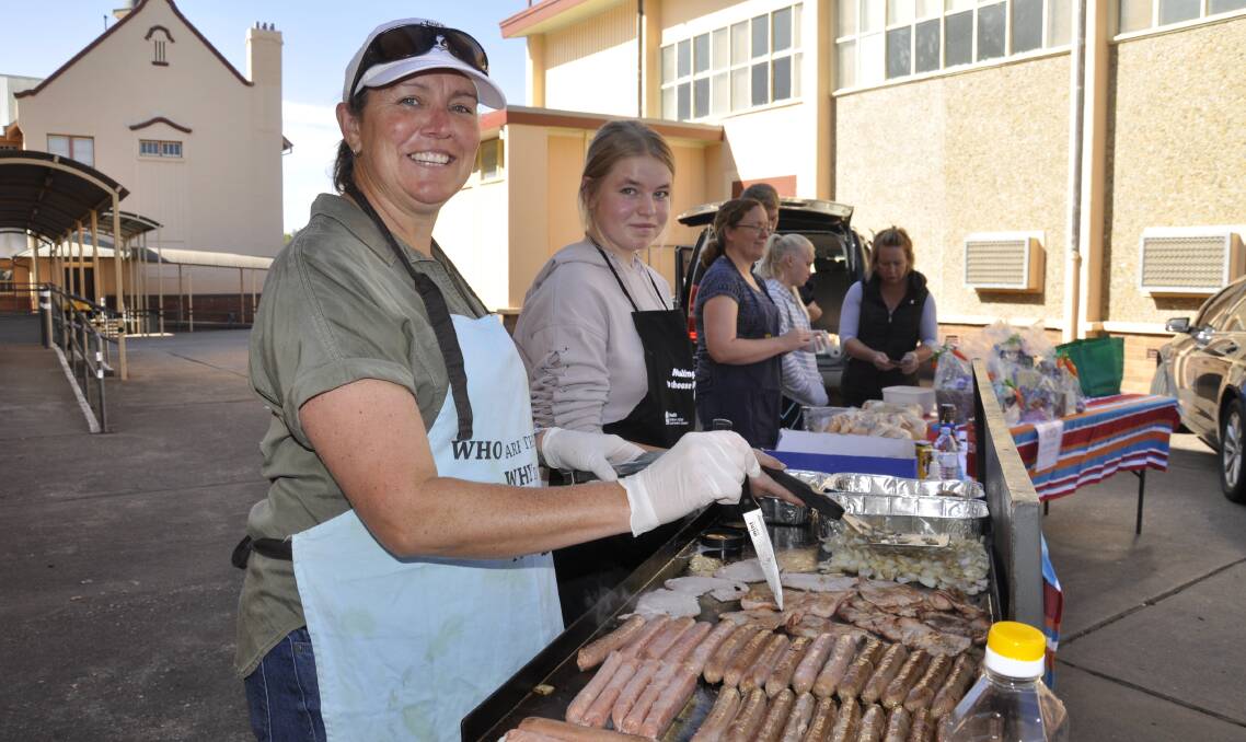 DEMOCRACY SAUSAGE: Renee and Meg Woodberry at the sausage sizzle at the Goulburn High polling booth on Saturday. Photo Louise Thrower.