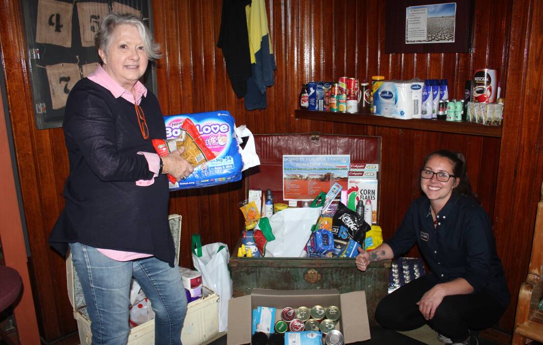 DONATIONS: Judy Bourne and Sara McFarlane at the Great Southern Hotel, showing some of the items that have were donated for the Fill a Float appeal held in August, 2018. Photo David Cole. 
