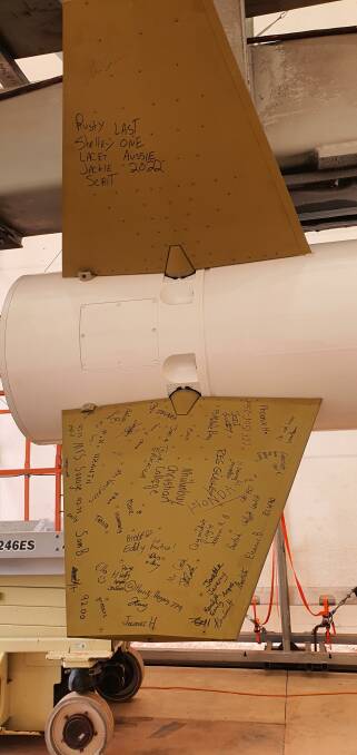 Local students signed the tail fins of the NASA rocket.