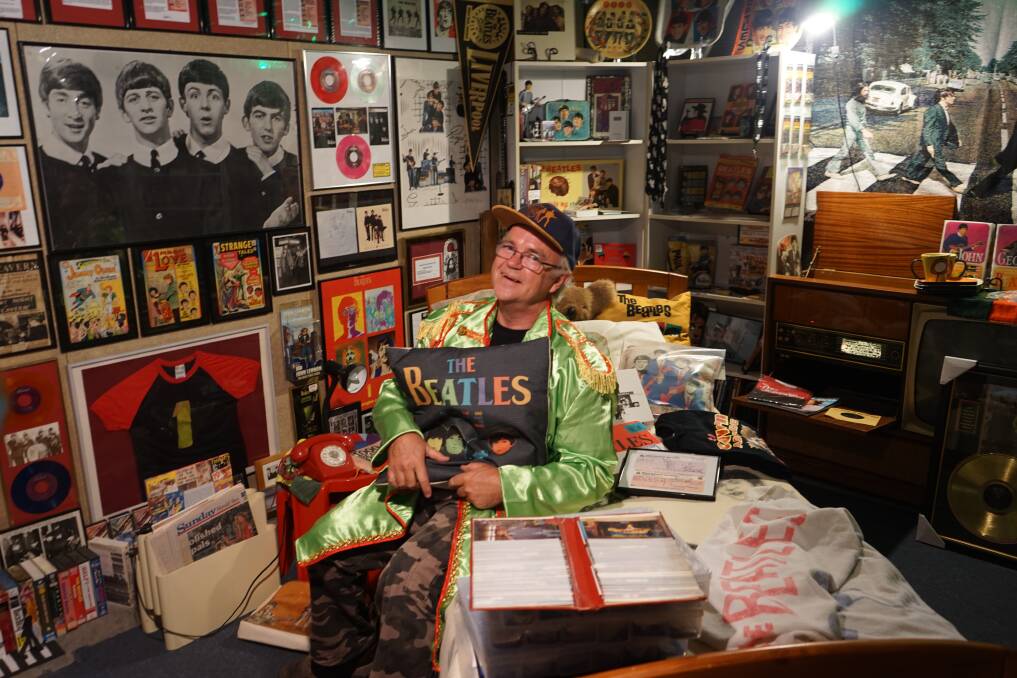 Music: Dallas Atkins and part of his collection of The Beatles memorabilia. Photo: Clare McCabe