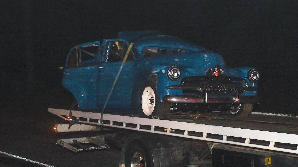 Awful sight: The FJ Holden is towed away on Saturday evening from the location of the deadly crash south of Wangaratta. Picture: MARK JESSER 