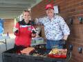 Democracy sausage: Jess Webster and Ben Williams serving up snags at the P&C barbecue at Goulburn West Public School. Photo: Sophie Bennett. 