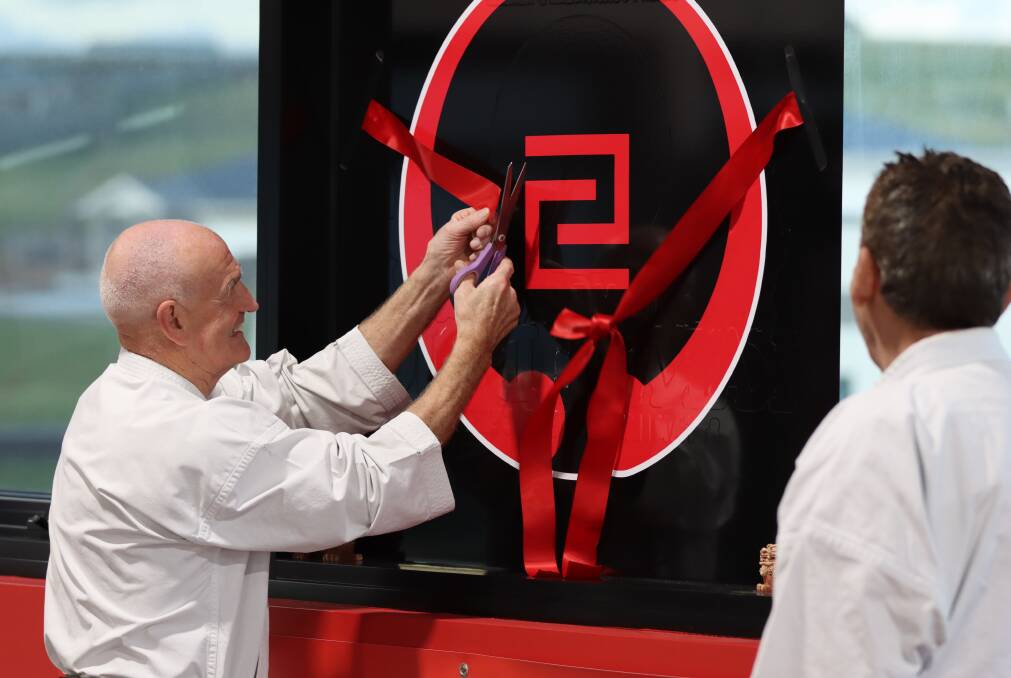 Sensei Ernie Molyneux cuts the ribbon to declare the dojo open on November 14. 