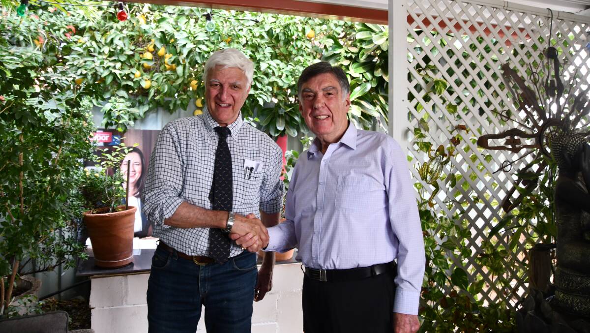 Old foes Bob Katter and former Labor state minister Tony McGrady shake hands at the latter's Mount Isa home. Mr McGrady craftily made sure an election poster of Annastacia Palaszczuk was in shot.