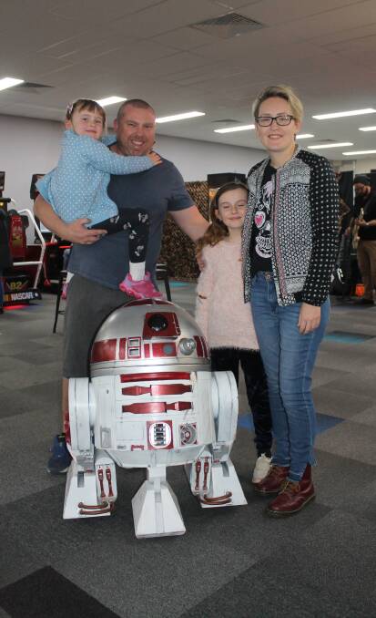 Family business: Owner-operators Greg Appleton and wife Miranda Heath with their children Millie and Elanor, and a working custom droid made by Paul O'Malley.