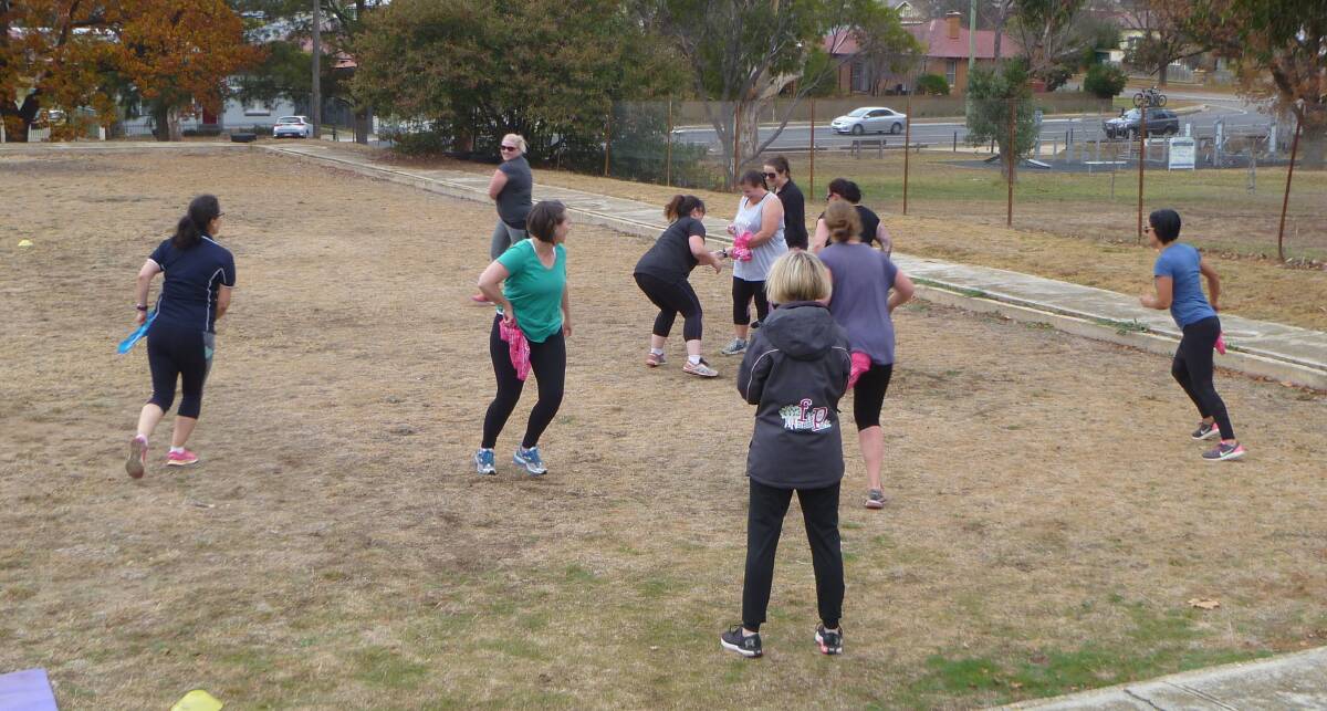 Warming up for Fitness in the Park with a game of bandanna tag. Angela says her participants love the fact they can also bring their kids along. Photo - Jennifer Wallace.