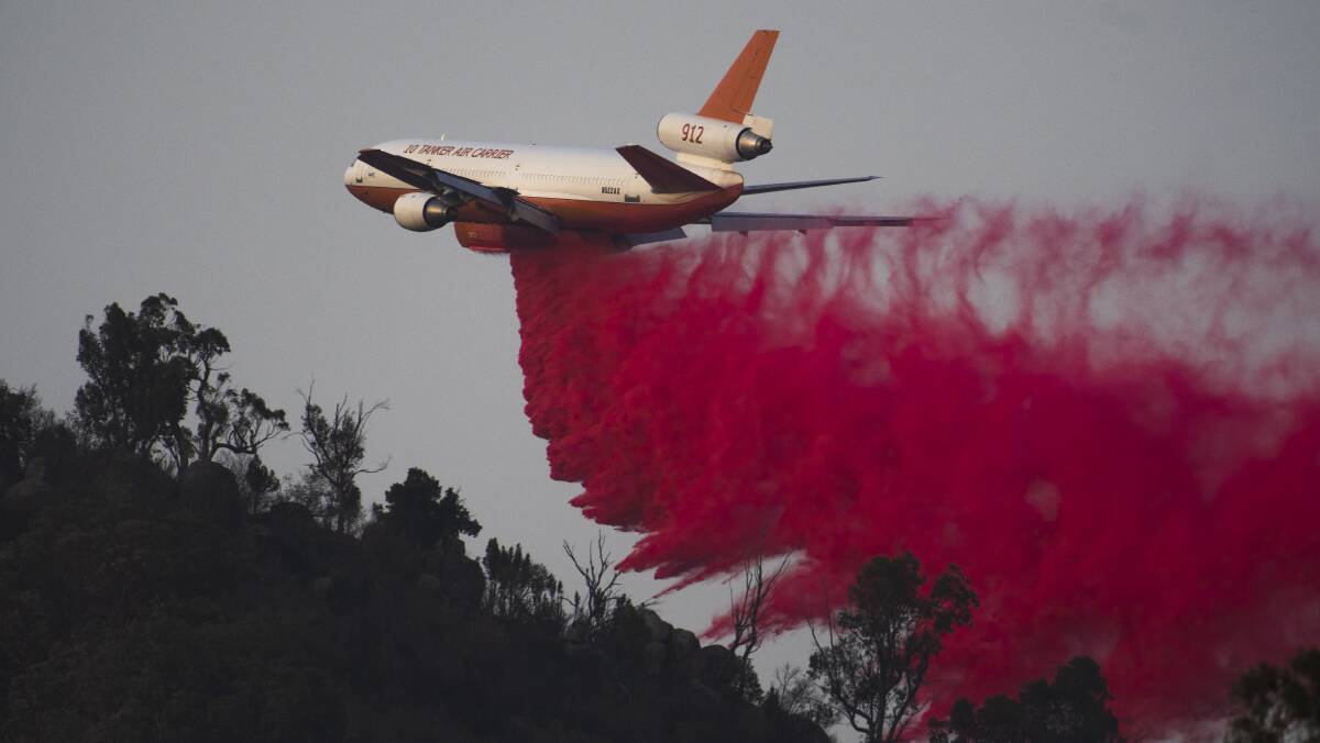 An air tanker drops fire retardant near Tharwa during the Orroral Valley fire near Canberra earlier in the year. Picture: Dion Georgopoulos
