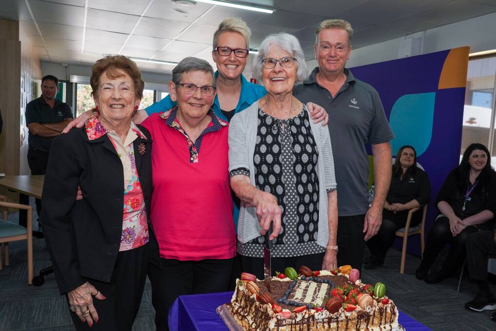 Day Club members and Goodwin Aged Care Services staff cut the cake at the celebration of the Queanbeyan Day Club's new location. Picture supplied 