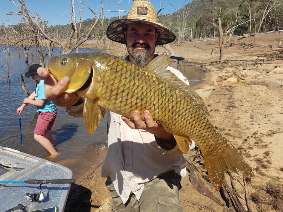 WHOPPER: Shaun Dickson with a Wyangala carp. Photo: Gina Guinane