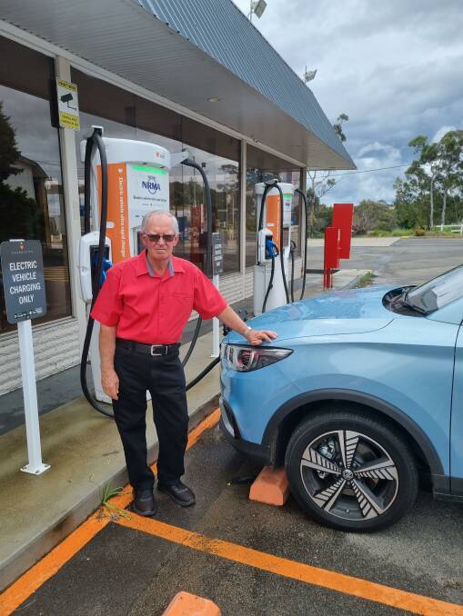 The Goulburn Group member Phil Irvine charging his MG ZS EV at the Gateway Service Station. He reckons it costs him $2 a week to run the car and he can get around town for a month on one charge. Photo: Domonic Unwin