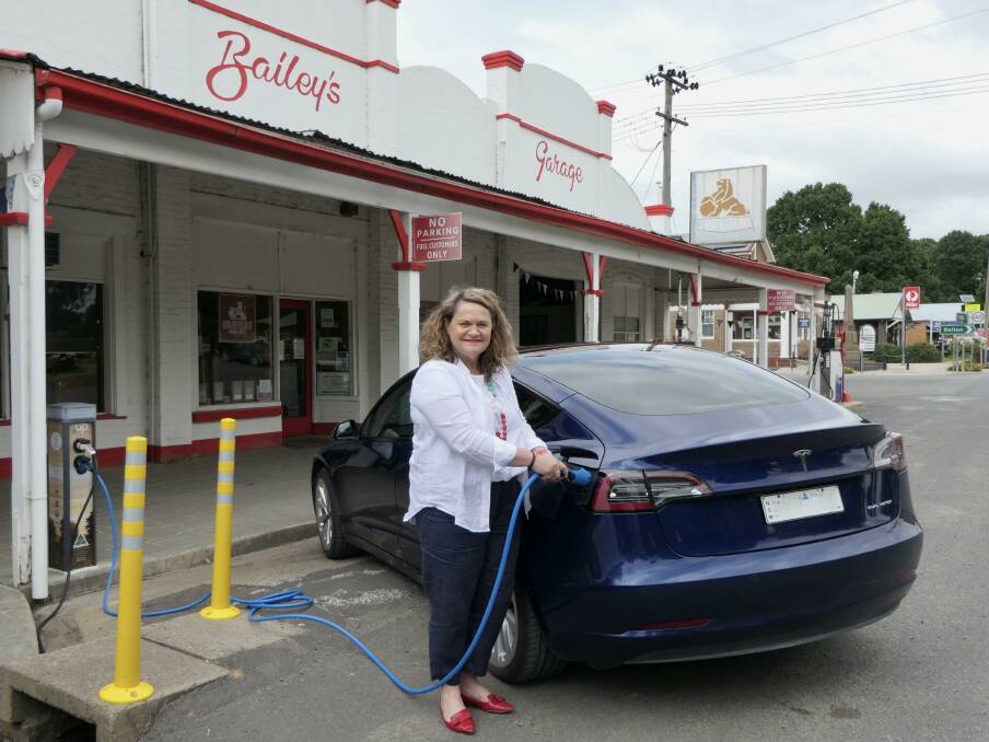 Goulburn MP Wedny Tuckerman tries out the new charging station at Bailey's Garage in Gunning. Photo: supplied