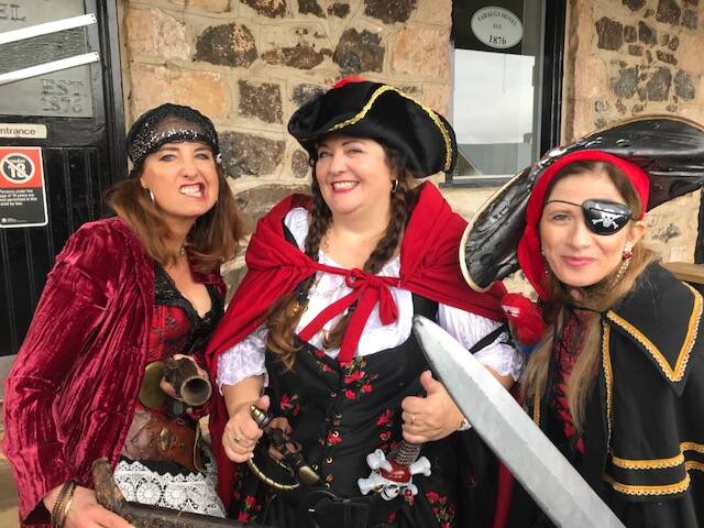 Spotted colourfully dressed for a pirate themed wedding in Taralga recently were Ann Buchner, Dee Henshaw and Liz Hovey, all from Sydney. Photo: Kim Lewis
