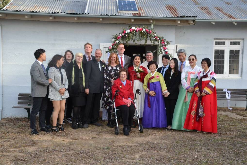 BEAUTIFUL DAY: Bride and groom, Eun Cho and Cormac Bozzetto, outside St John's Anglican Church, Towrang with their families. Photo: courtesy Helena Bozzetto
