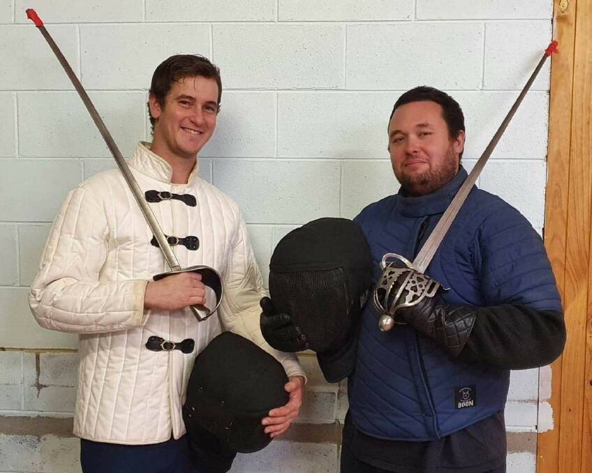 Brent Hickey, holding a Victorian era military sabre, and Daniel Wise, holding a highland broadsword. Both weapons have rubber tips on the point to make them safer on the thrust.