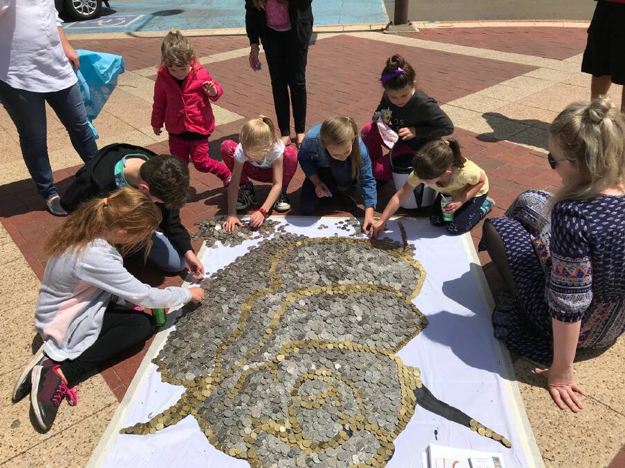 Last year, members of the community enjoyed taking part in the construction of the coin mural.