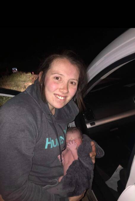 Jarrod Hando snapped this photo of Rhiannon and Airlie moments after the birth on Windellama Road, with Airlie wrapped in a towel they found in the car.