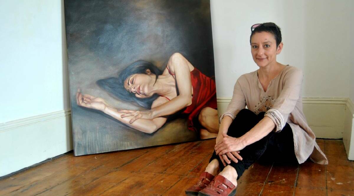 REAL DEAL: Gunning artist Margarita Georgiadis pictured with an older work from an exhibition in Goulburn in 2012.