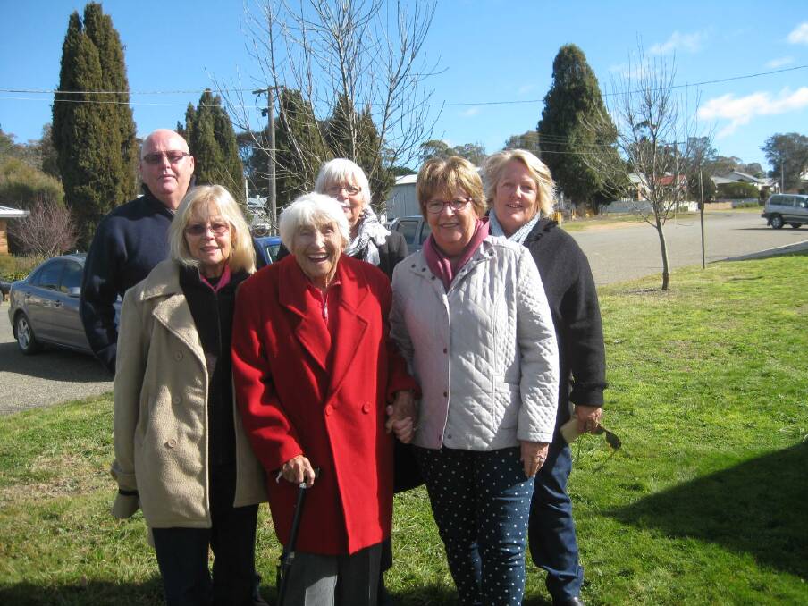 HAPPY DAYS: 97 year-old Ettie Rodrom (in red) was taken on a nostalgic visit back to Gunning where she was born, seen here with family outside Pye Cottage. Photo: supplied
