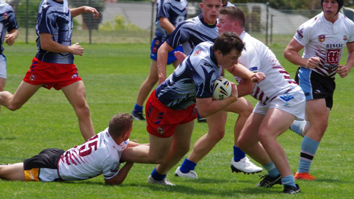 Tackle: Monaro players land a tackle during the Under 18's rep trial game against Illawarra on Saturday morning. Photo: Darryl Fernance. 