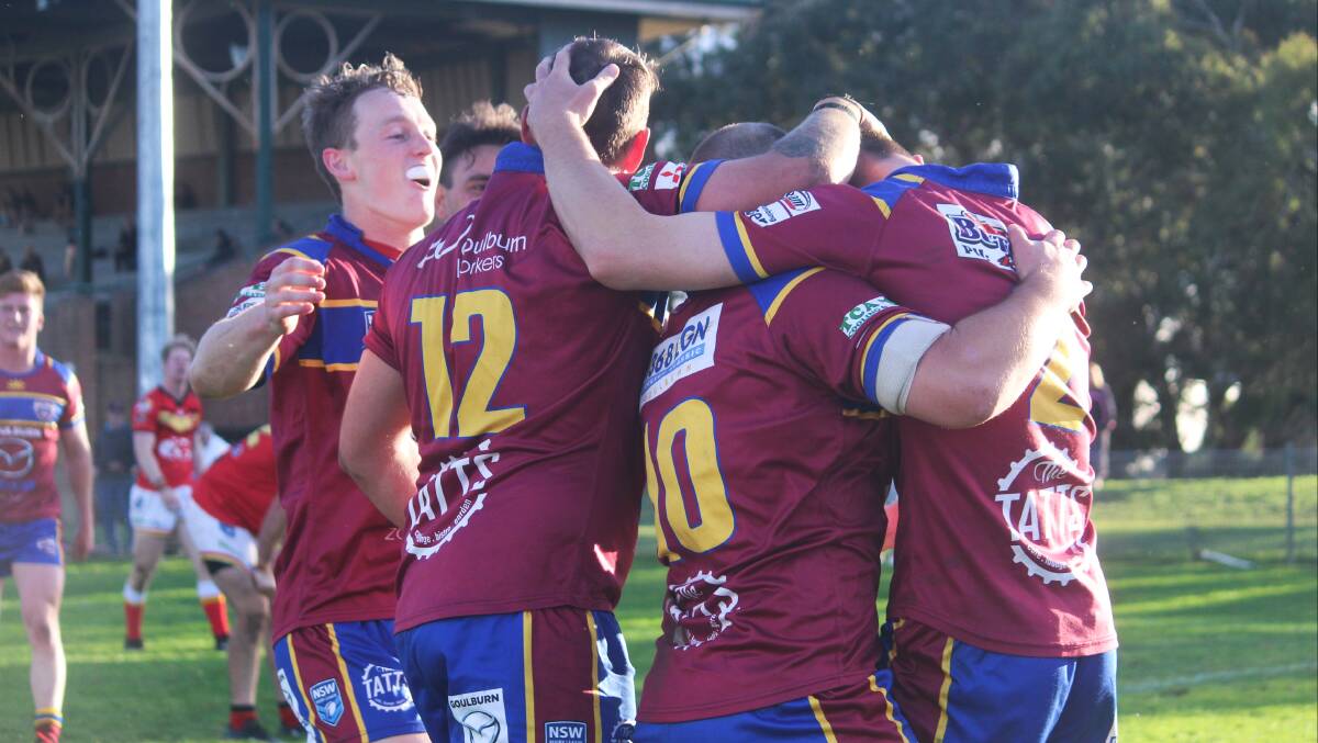 Another one: The Bulldogs celebrate after Steve Cummins (right) crossed for his fourth try of the day. Photo: Zac Lowe.