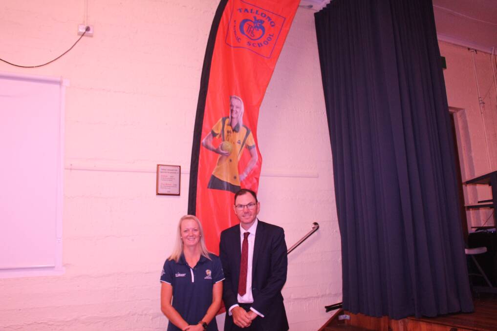 Honoured: Ellen Ryan with Tallong Public School principal, Scott Osborne, in front of the new Ryan house's flag. Photo: Supplied.