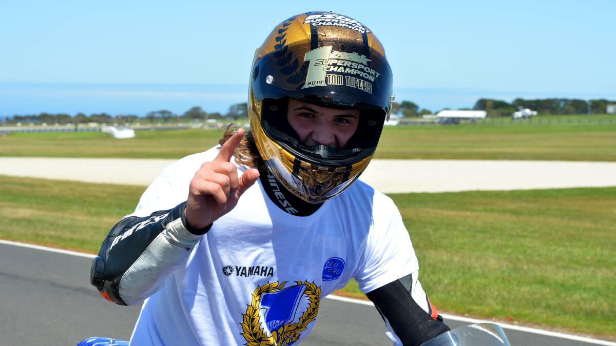 Celebrate: Tom Toparis in the gold helmet and special shirt which his team brought out at Phillip Island once his victory was assured. Photo: Russell Colvin.