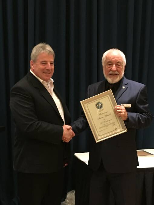 Congratulations: Lance Miller (left), State President of SSAA with Ken Kenchington who is holding his Gold Meritorious Service award. Photo: Supplied.