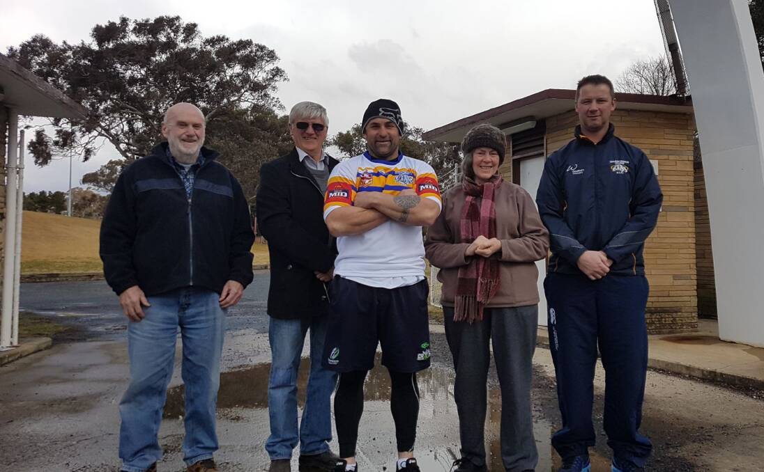 A good cause: From left: Ian Irwin, Dick Kearins, Mick Dodson, Maggie Irwin, and Joe Stephens, all standing in front of the Goulburn Workers Arena, where the Magpies will take on Goulburn this weekend. Photo: Zac Lowe. 