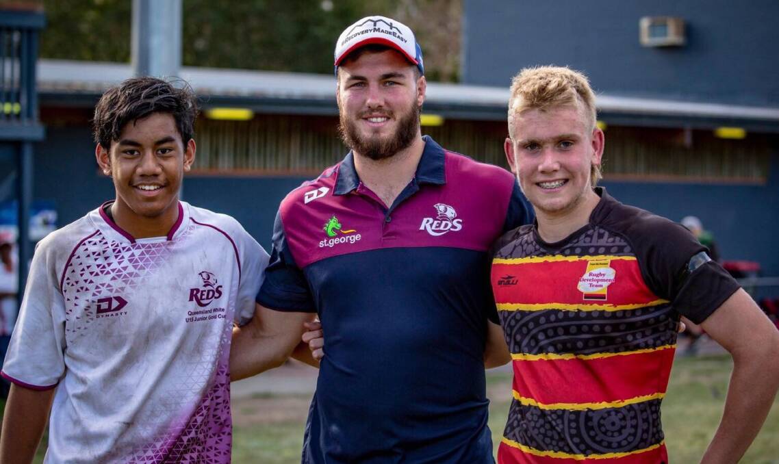Awarded: Dylan Biles (right) receives a Man-of-the-Match award during his time with the Lloyd McDermott Rugby Development team in October. Photo: Supplied.