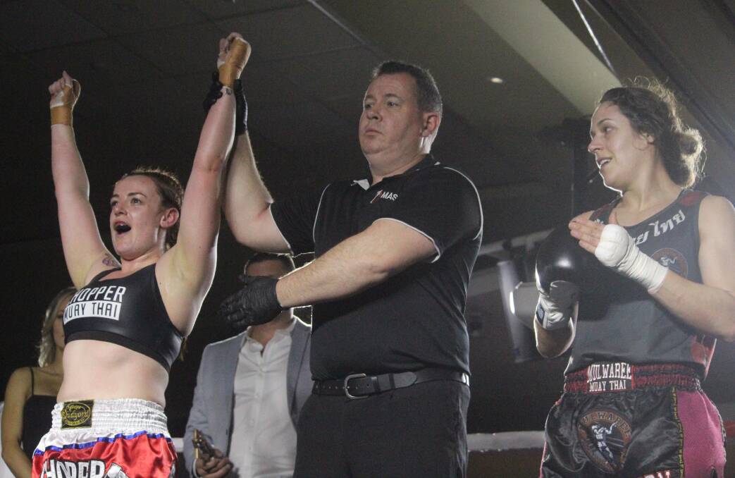 Split decision: Tegan Taylor (right) congratulates her opponents, Zoe Whitehouse, as the result is announced after their fight. Photo: Zac Lowe.