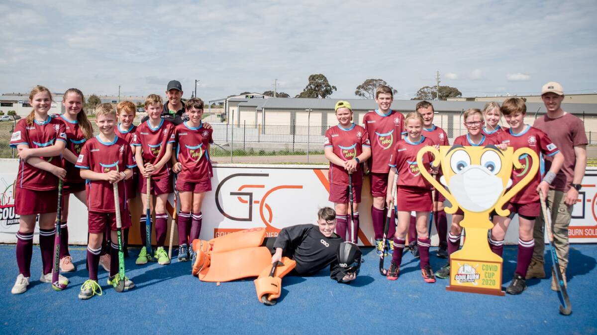 Posing: After all of the junior matches on Saturday, the teams posed with Mr COVID Cuppy. Photo: Goulburn District Hockey Association.