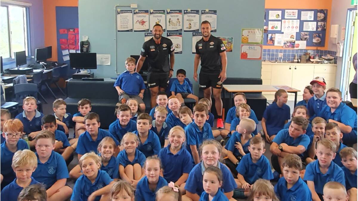 Visiting: Benji Marshall (back, left) and Luke Brooks with the students from Tallong Public School on Tuesday. Photo: Supplied.