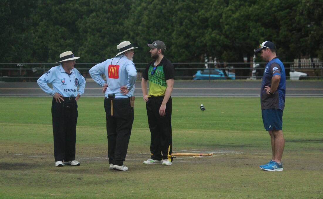 Assessing the damage: Hibo captain Luke Hayward (in green) and Stags captain Simon Fitzsimmons assess the ruined pitch alongside the umpires after Saturday's deluge. Photo: Zac Lowe.