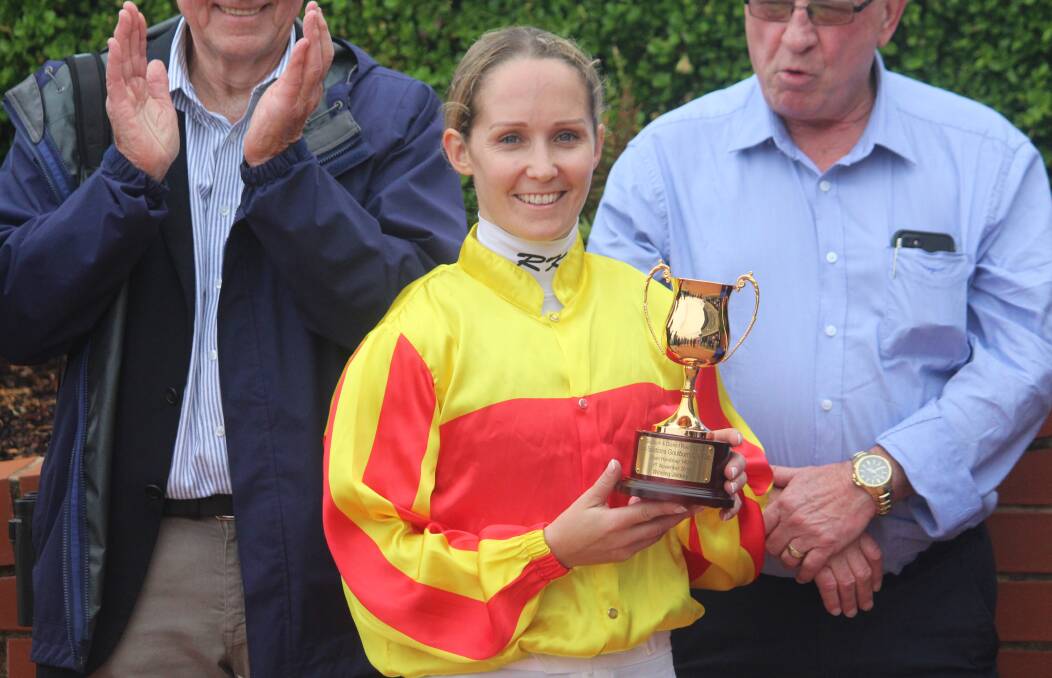With the trophy: Rachel King poses for photographers with the Goulburn Cup after her win. Photo: Zac Lowe.