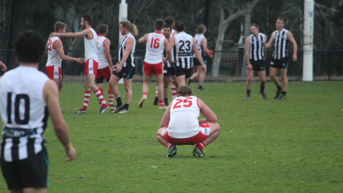 Dejected: Leam Patton takes a few moments after Sunday's game to reflect on a difficult match for the Swans. Photo: Zac Lowe.