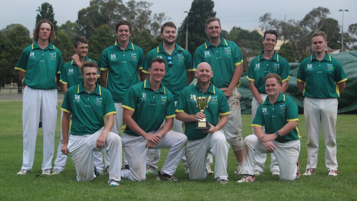 Post-match: Dane Stevenson (holding trophy) with the rest of the Hibo Green side following their grand final victory over Workers Stags. Photo: Zac Lowe.