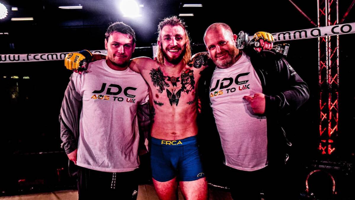 Well fought: Joel Downey-Cave (centre) celebrates in the ring after an immensely satisfying performance against Jonno Mears. Photo: Graham Finney Photography. 