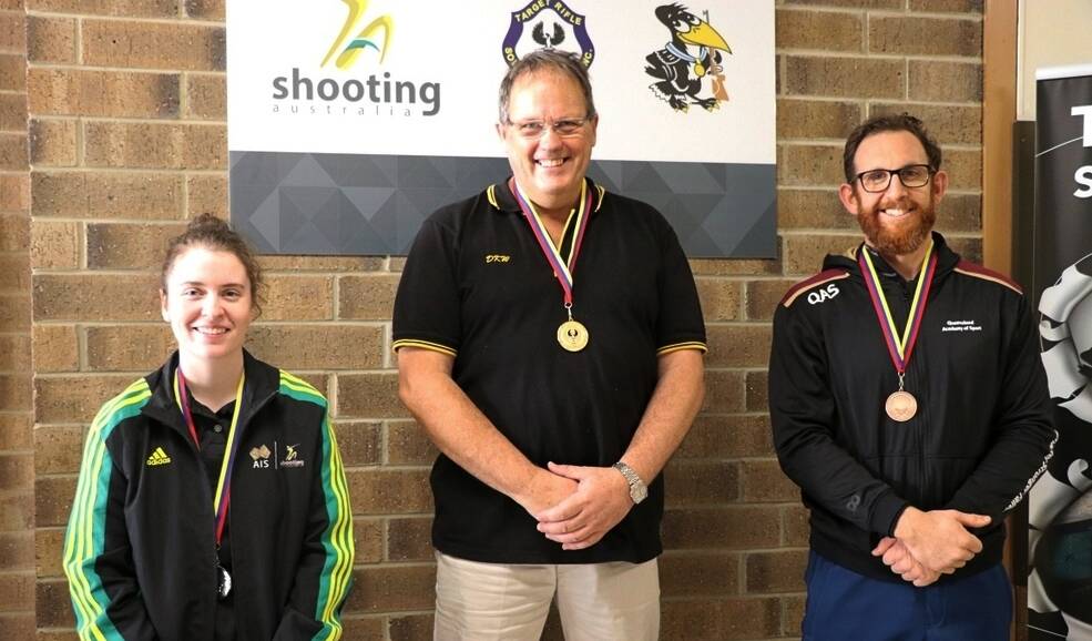 Winner: David Wright (centre) is no stranger to the weight of a medal around his neck, with dozens of titles from more than 40 years of competitive shooting. Photo: Supplied.