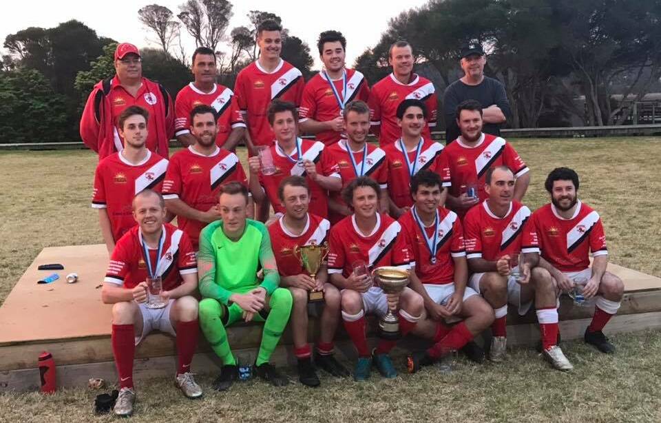 Champions: The Bega Devils FC first grade team following their most recent premiership victory in 2019, which they won under Moffitt's guidance. Photo: Bega Devils FC/Facebook.