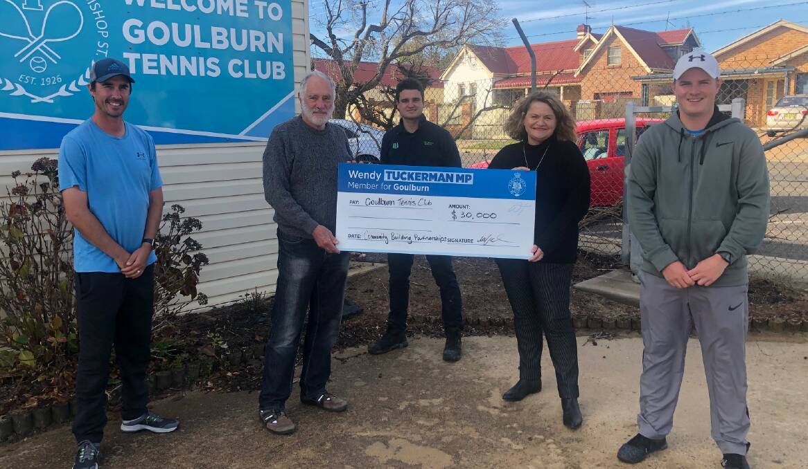 Let there be light: Wendy Tuckerman presents the Goulburn Tennis Club with a cheque for the grant funding. Photo: Supplied.