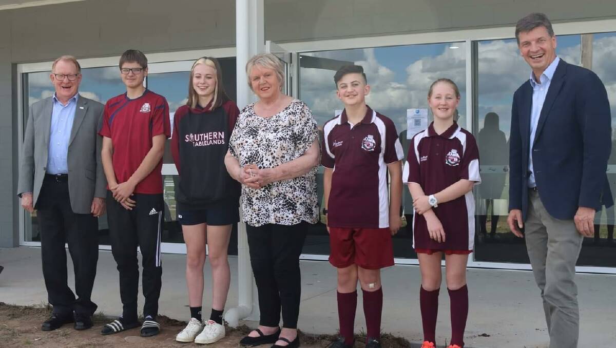 Welcomed: Goulburn Mulwaree Council mayor, Bob Kirk (left) with Member for Hume, Angus Taylor (right), and the late Graham Coe's widow, Carolyn Bennett (centre), alongside some of the local juniors at the opening of the Graham Coe Pavilion. Photo: Supplied.