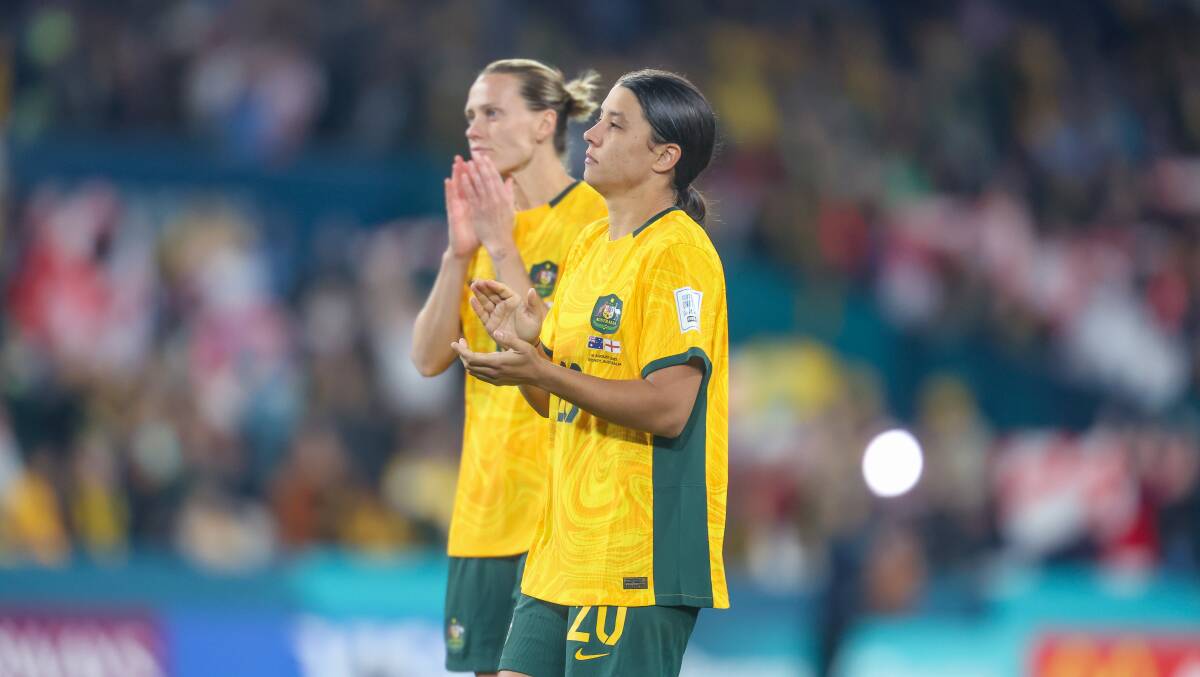 A disappointed Emily van Egmond and Sam Kerr thank the sell-out crowd at Stadium Australia on Wednesday night after the Matildas' 3-1 loss to England. Picture by Adam McLean