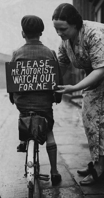 A mother fastens a notice onto her son's back before he sets out, circa 1937. Photo: Hulton Archive, supplied